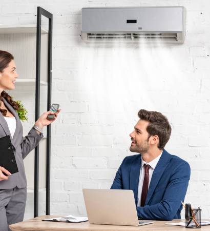 smiling-businesswoman-holding-remote-control-while-2024-11-18-05-09-04-utc-scaled-r7s4m74akhbi8dbw870es20if240nr2nrsk4ctxpg4